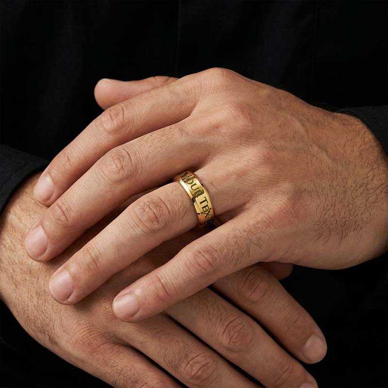 Personalized gold men's ring with custom text engraving worn on model's hand