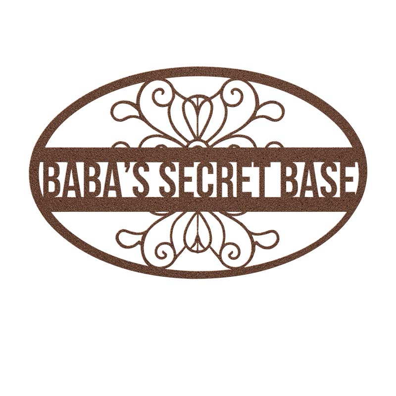 Decorative copper metal sign with 'Baba's Secret Base' text on a white background