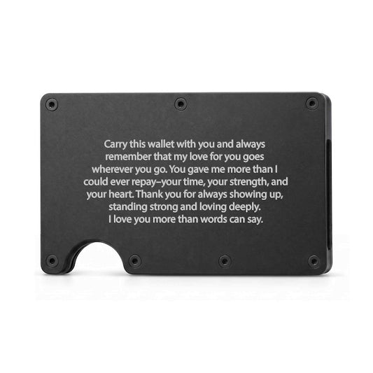 A black minimalist engraved metal wallet featuring exposed corner screws, a thumb cutout at the bottom left, and a centered laser-engraved sentimental message expressing love and gratitude for Dad.   