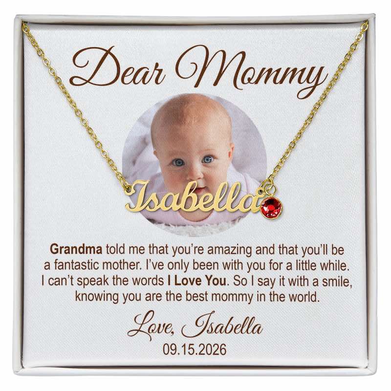 new mom gifts: personalized gold nameplate necklace spelling “Isabella” with a red birthstone charm, presented in a gift box with a customized message card featuring a baby’s photo and a heartfelt message for Mommy.