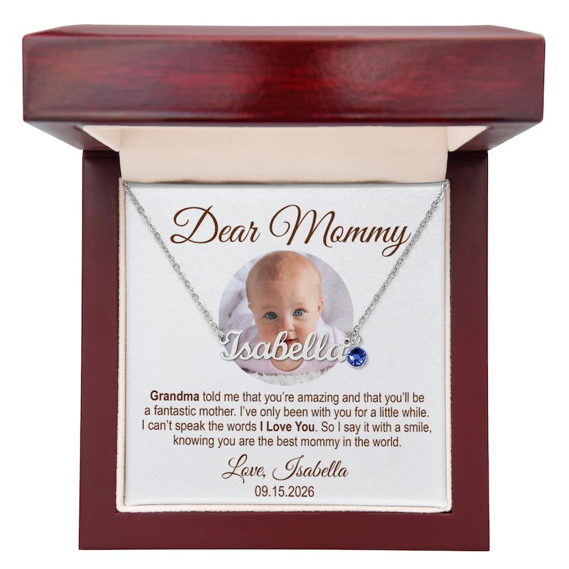 new mom jewelry: personalized silver nameplate necklace spelling "Isabella" with a blue birthstone charm, displayed in a mahogany-style wooden gift box with a customized photo message card, against a white background.