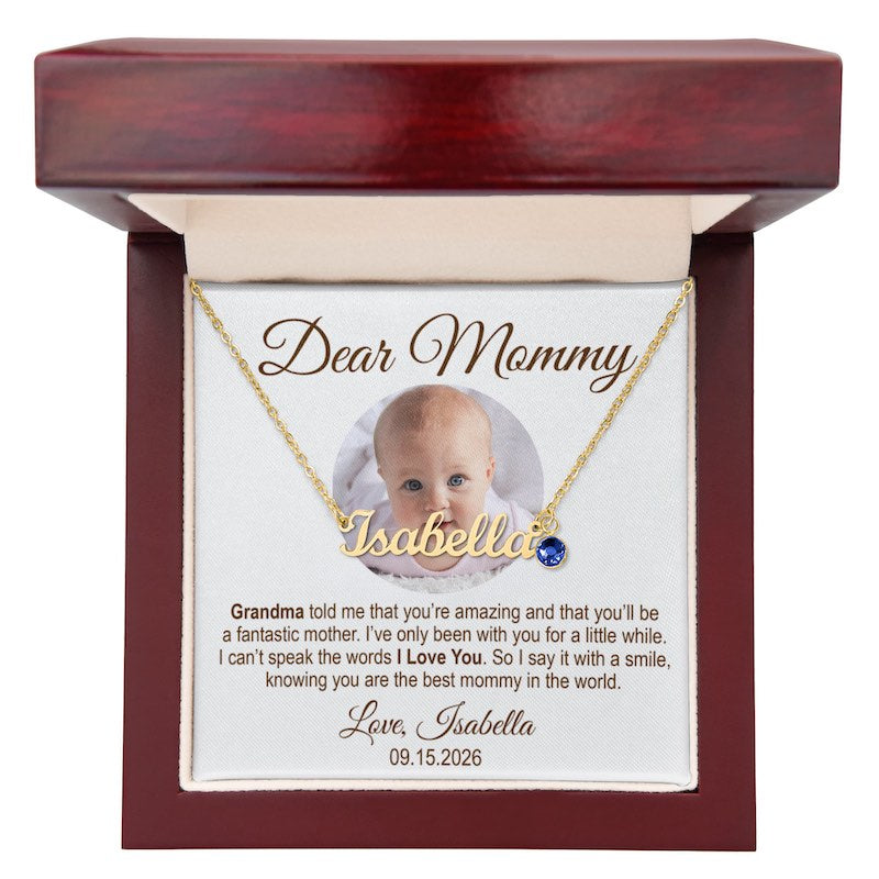 best gift for new mom: personalized gold nameplate necklace spelling "Isabella" with a blue birthstone charm, displayed in a mahogany-style wooden gift box with a customized photo message card, against a white background.