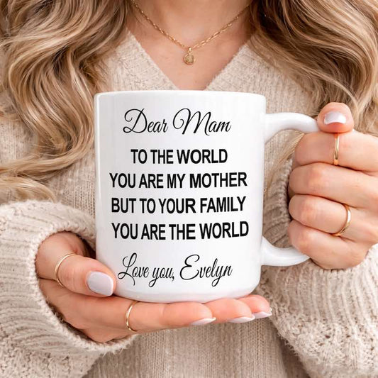 Personalized Mom Mug: woman holding a white ceramic mug featuring a heartfelt message for Mom, customized with the name "Evelyn," while wearing a cozy cream sweater.
