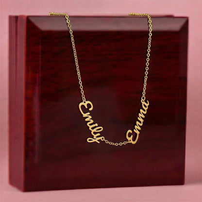 Gold necklace with 'Emily' and 'Emma' on a red box with pink background