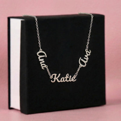 Name Necklace with 'Katie' 'Ava' and 'Ana' cursive name pendats on a black box with pink background