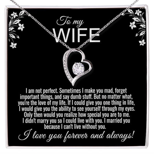 Silver heart necklace with a round crystal, displayed in a white gift box. The black card inside reads: "To my WIFE," followed by a message starting with "I am not perfect" and ending with "I love you forever and always!"