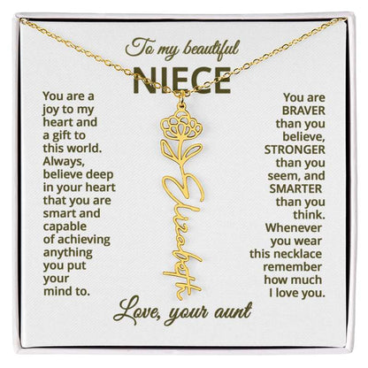 Gold name necklace and chrysanthemum  flower pendant on a card with sentimental message for niece on a white background 