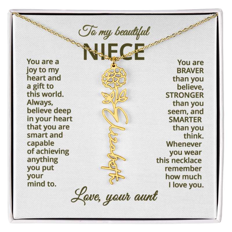 Gold name necklace and marigold flower pendant on a card with sentimental message for niece on a white background 