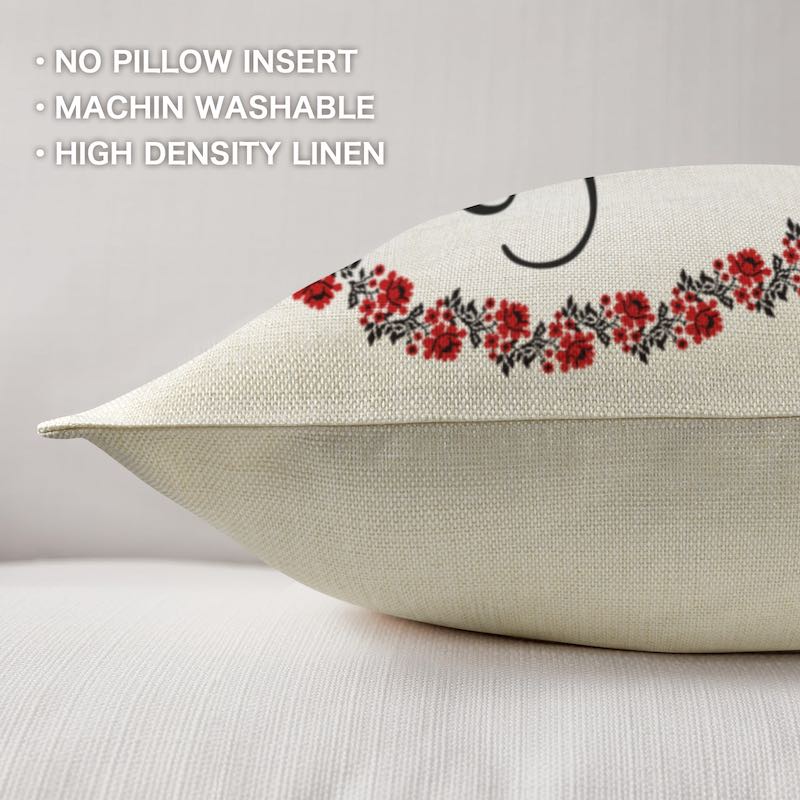 Decorative linen pillow with floral embroidery on a light background