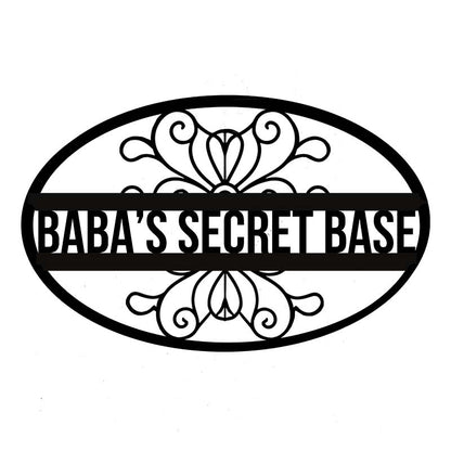 Decorative sign with 'Baba's Secret Base' text and floral designs on a white background