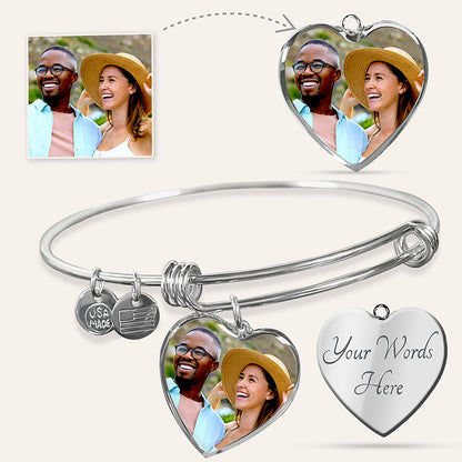 Silver engraved bangle bracelet with heart-shaped charms featuring a couple's photo and customizable text on a white background.