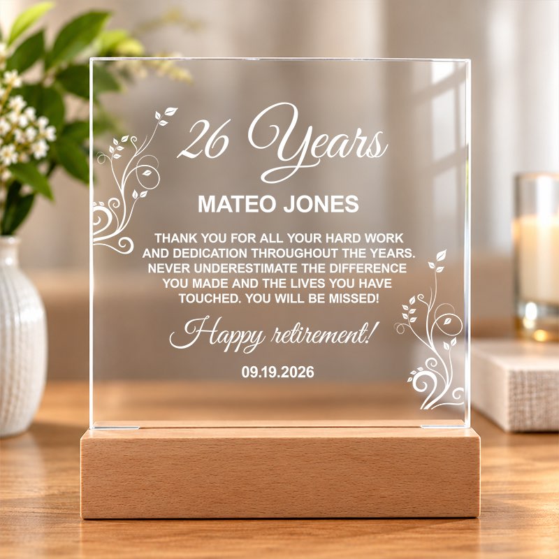 Personalized clear acrylic retirement plaque on a wooden stand with a custom engraved message, set on a sunlit table. - Gifts For Family Online