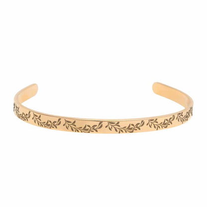 Rose-gold bracelet with leaf pattern on a white background