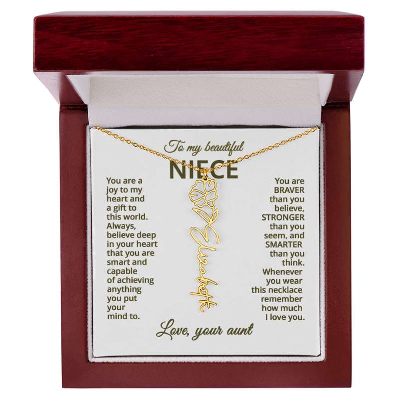 Gold name necklace and morning glory flower pendant on a card with sentimental message for niece on a hite background in a wooden box