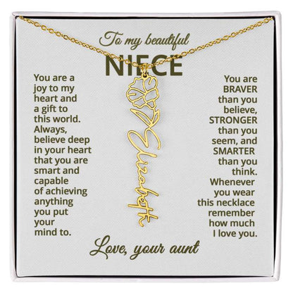 Gold name necklace and morning glory flower pendant on a card with sentimental message for niece on a hite background 