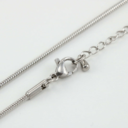 Close-up of a silver snake necklace chain with a lobster clasp, indicating the product is a replacement attachment for jewelry making.