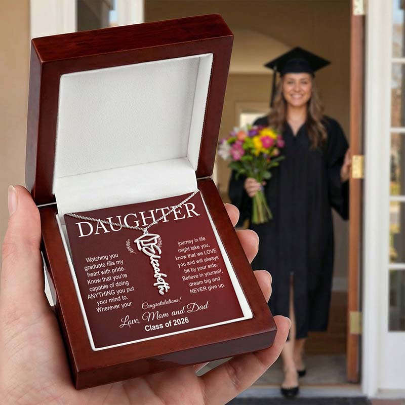 Graduation gift for a daughter with a necklace in a wooden box, held by a hand, with a graduate in the background.
