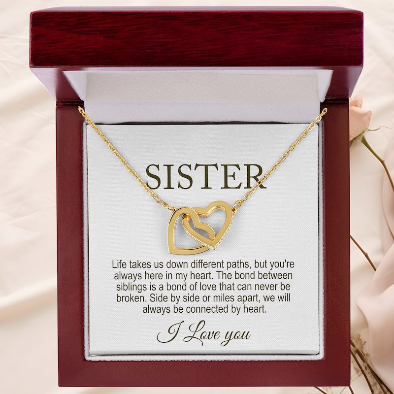 sister necklace: Gold necklace with interlocking hearts in a gift box with a message for a sister.