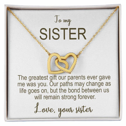 Gold necklace with interlocking hearts on a card addressed to 'my Sister' with sentimental text.