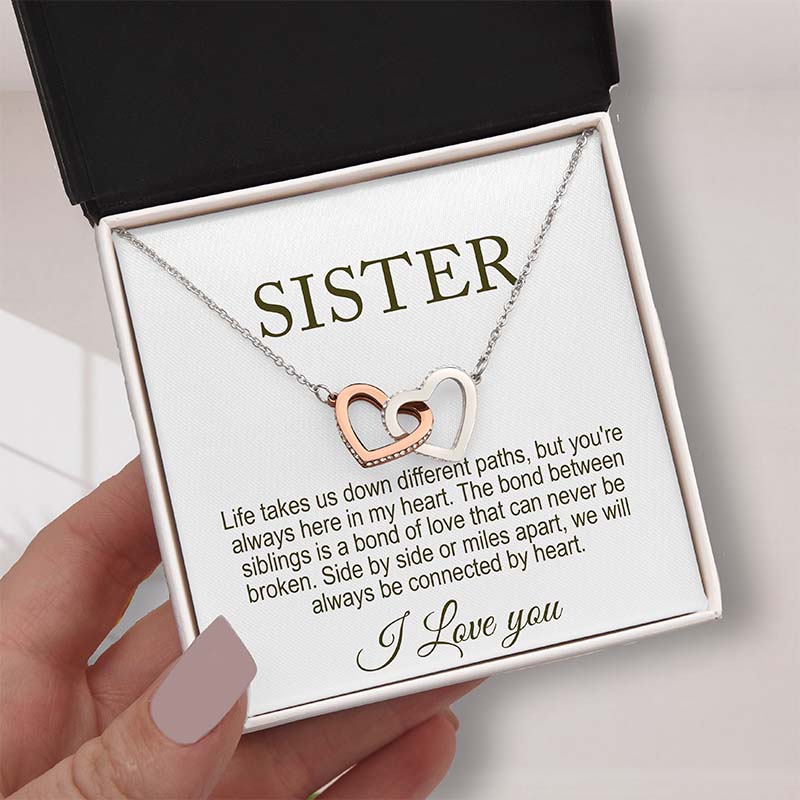 sister's personalized gift: Necklace with interlocking heart pendants in a box with a sentimental message for sister.