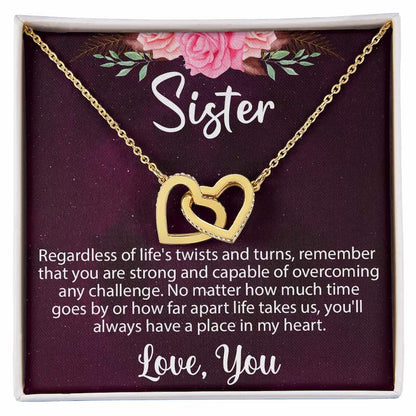 Sister birthday gifts: A gold interlocking heart necklace in a gift box with a heartwarming message card for a sister.