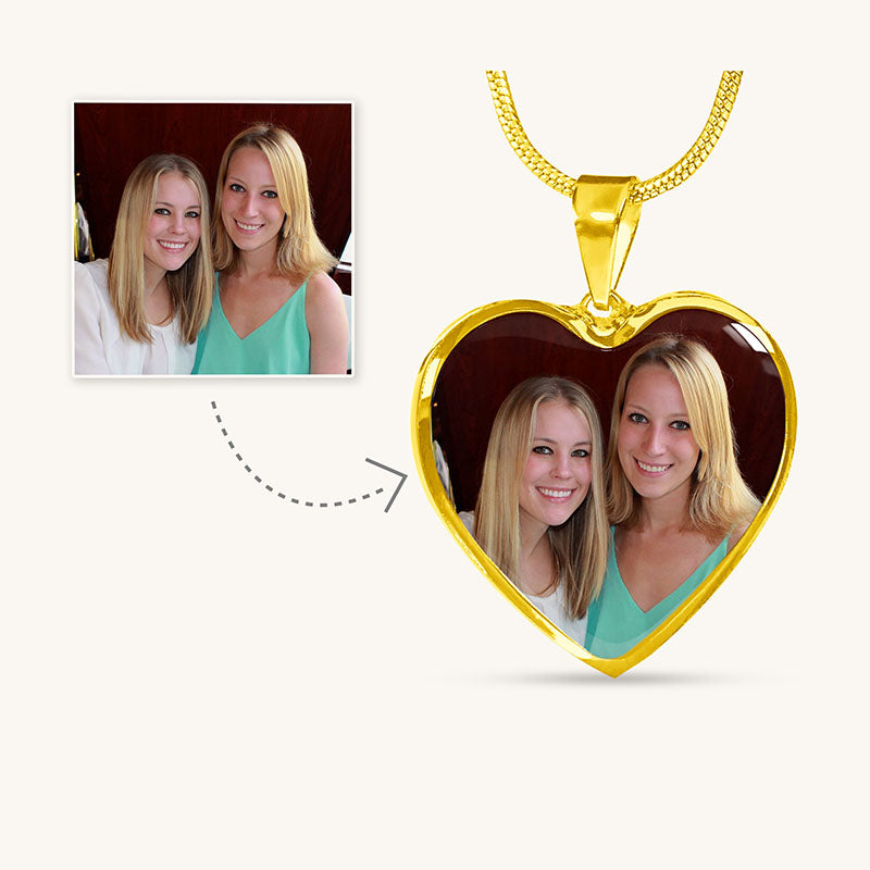 Gold heart-shaped pendant with a photo of two women on a white background