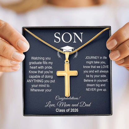 Gold cross necklace in a box with graduation-themed message for a son graduating college, held by two hands.