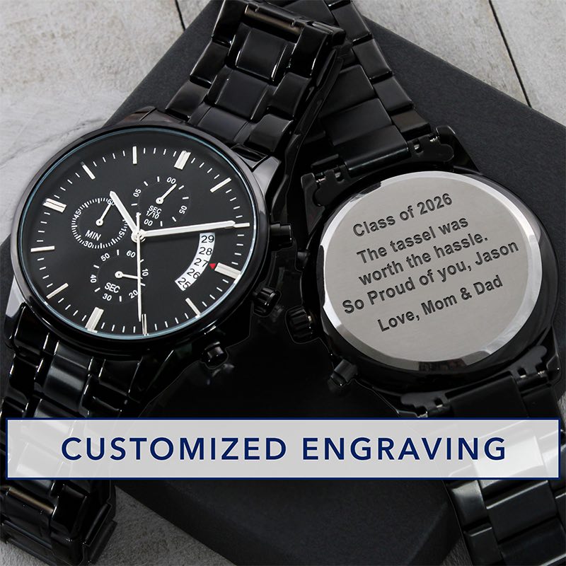 custom grad gifts: black wristwatch with engraved message on a black gift box against a gray surface.