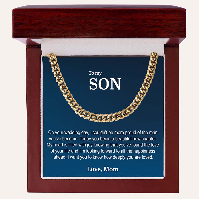 unique gifts for son on wedding day: gold Cuban link chain necklace with a personalized card, set against a beige background.