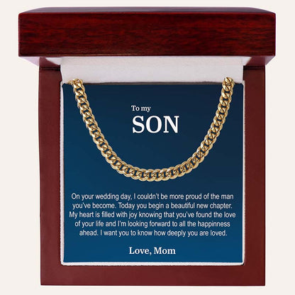 unique gifts for son on wedding day: gold Cuban link chain necklace with a personalized card, set against a beige background.