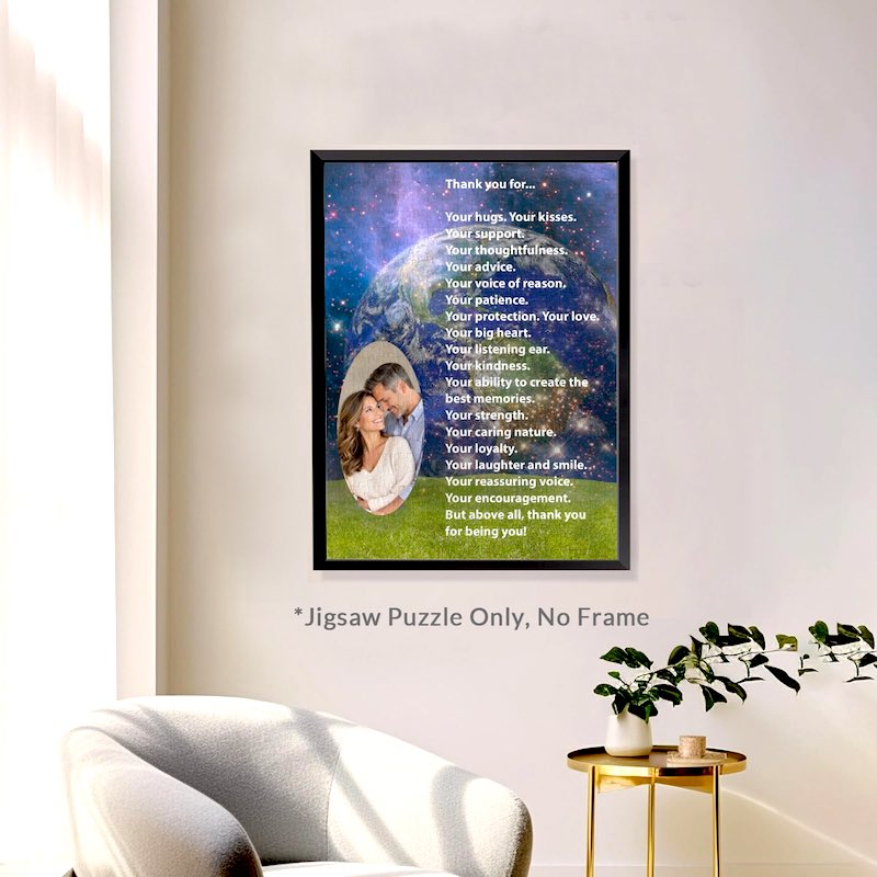 Lifestyle display showing the custom "Thank You" photo puzzle mounted in a thin black frame on a beige wall above a grey armchair. A small gold side table with a potted plant stands nearby, and small text below reads "*Jigsaw Puzzle Only, No Frame".   