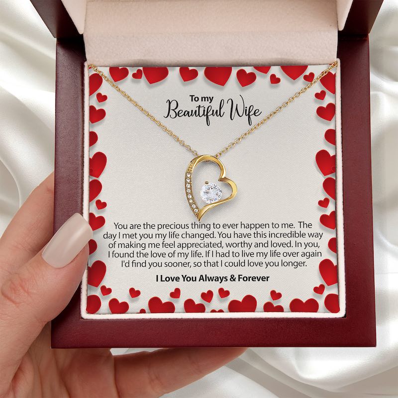 Romantic wife gift: heart-shaped gold necklace in a gift box with a love message for a wife.
