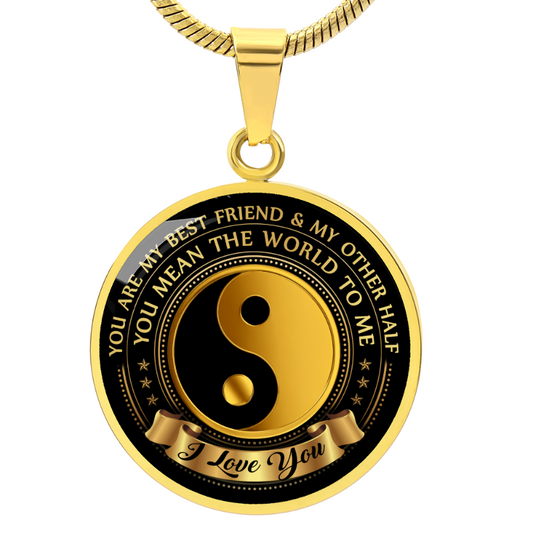 engraved round pendant, gold and black pendant with yin yang symbol with custom text, against a white background