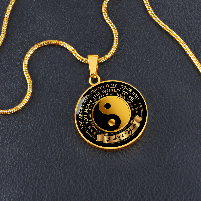 Yin Yang Gold and black pendant necklace on a dark background with sentimental message.