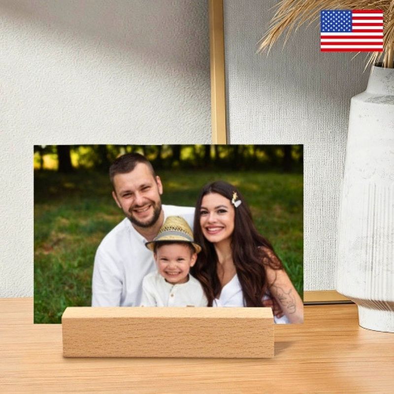 Customized acrylic photo frame with a natural wooden base, displayed on a tabletop