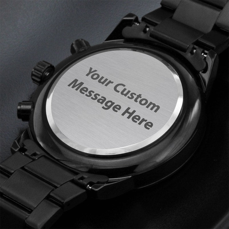 Black watch with engraved message on a dark background