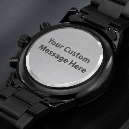 Black watch with engraved message on a dark background