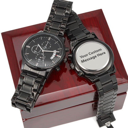 Two black watches on a red box with one showing a romantic message.