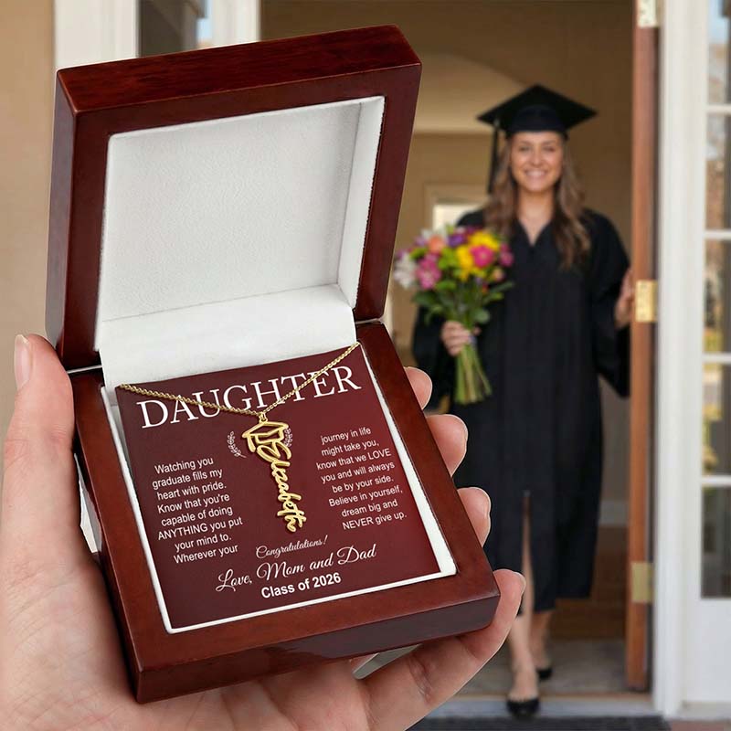 Daughter college graduation gift with a necklace and card, held by a hand, with a graduate in the background.