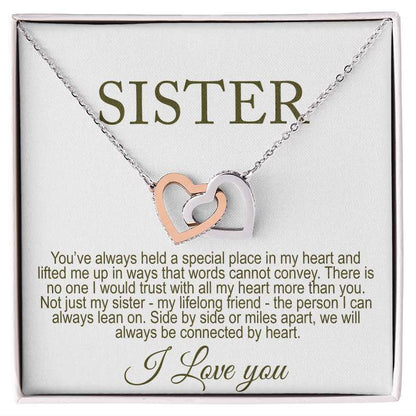 Necklace with interlocking heart pendants on a card that reads 'Sister' and a sentimental message.