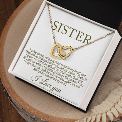 Gold necklace with interlocking hearts on a 'Sister' card with a special message displayed in a gift box.